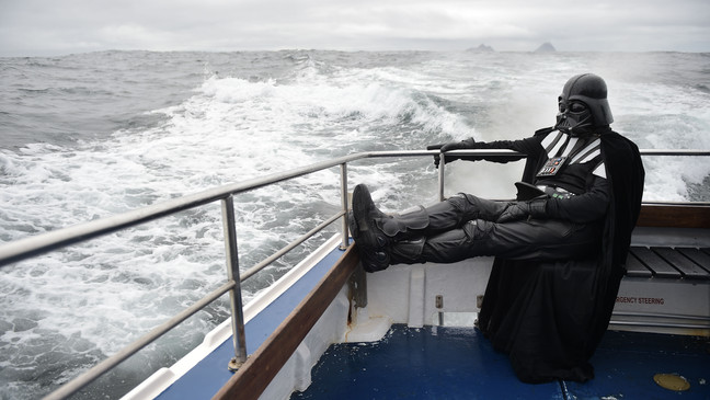 PORTMAGEE, IRELAND - MAY 04: A Star Wars fan dressed as the character Darth Vader takes a boat trip to the Skelligs on International Star Wars day May 4, 2018 in Portmagee, Ireland. The first ever Star Wars festival is taking place against the backdrop of the famous Skellig Michael island which was used extensively in Episode VII and Episode VIII of the popular science fiction saga. The small fishing village of Portmagee which is closest to the location has seen a boom in tourism following the latest films. Today is known as May the fourth be with you day. (Photo by Charles McQuillan/Getty Images)