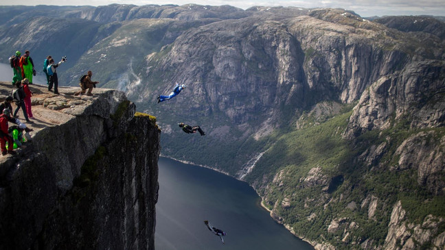 BASE jumpers jump from the 1000-meter Kjerag cliff in Lysebotn, Norway as part of the annual Heliboogie BASE jumping event. Heliboogie is organized by SKA Base and has been in existence since 1998. | Credit: Reel Peak Films