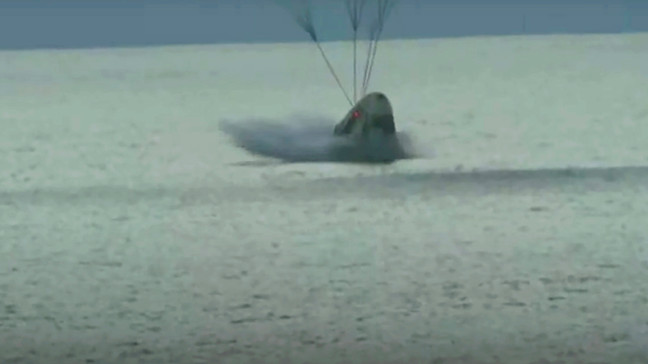 In this image taken from video a SpaceX capsule carrying four people splashes down in the Atlantic off the Florida coast, Saturday, Sept. 18, 2021. The all-amateur crew was the first to circle the world without a professional astronaut.  (Inspiration4 via AP)