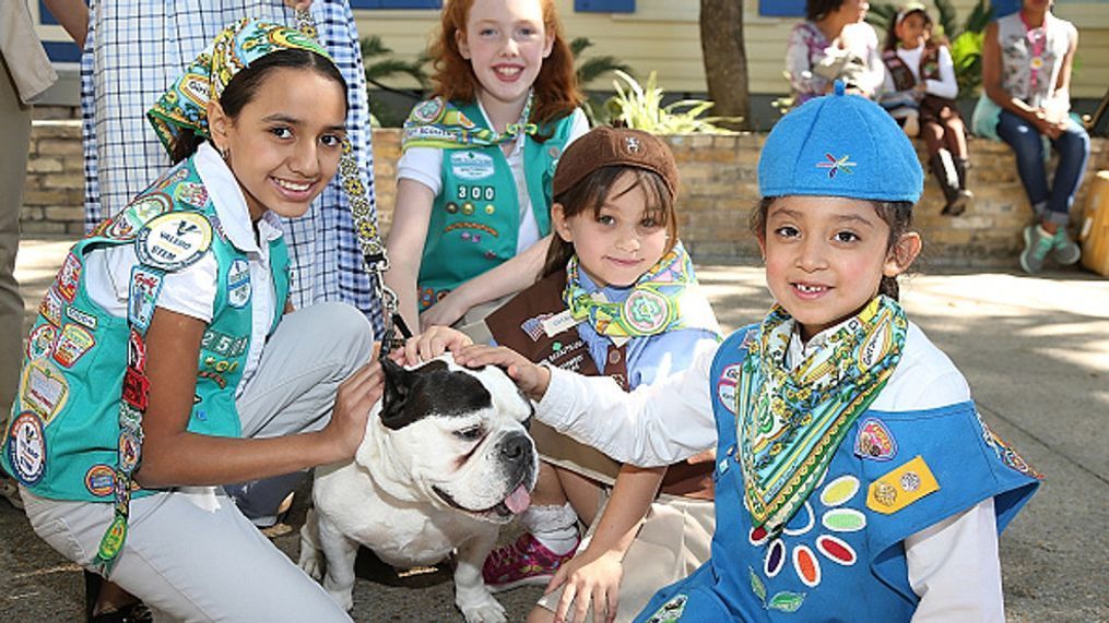 Girl Scouts pose with Rubble the dog in San Antonio, Texas.  (Photo by Gary Miller/Getty Images  for Marisol Deluna)