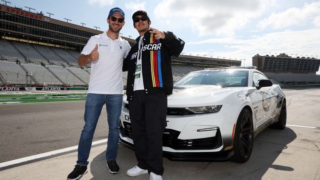 HAMPTON, GEORGIA - JULY 10: Daniel Suarez, driver of the #99 Freeway Insurance Chevrolet, (L)  and honorary starter, Mexican-American singer-songwriter Cuco pose for photos prior to a pace car ride prior to the NASCAR Cup Series Quaker State 400 at Atlanta Motor Speedway on July 10, 2022 in Hampton, Georgia. (Photo by James Gilbert/Getty Images)