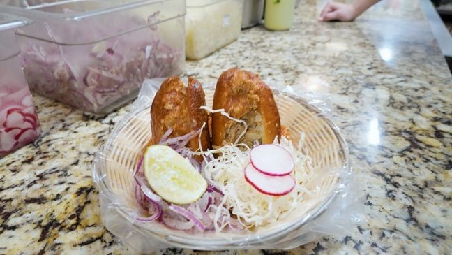 Let's Eat! San Antonio: Ro-Ho Pork & Bread-Pork Butt Carnitas Torta Ahogada: Birote bread with a spread of bean puree, Pork Butt Carnitas, drenched in tomato salsa, cabbage, pickled onion, radish, and lime.. (Amazing America TV)