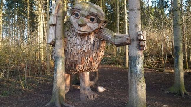 The "troll" statue Little Tilde by Danish recycling artist Thomas Dambo is pictured in Vallensbæk, Denmark, on March 23, 2023. - Danish recycling artist Thomas Dambo, best-known for his towering wooden troll sculptures, is sending fans on a complex quest to find his recently-completed hundredth troll, one of his fairytale-inspired creations named Moon Mother. (Photo by James Brooks / AFP) (Photo by JAMES BROOKS/AFP via Getty Images)