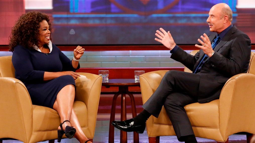 This Sept. 22, 2015 image released by CBS Media Ventures shows Oprah Winfrey, left, and Dr. Phil McGraw on the set of the "Dr. Phil." McGraw says he'll stop making new episodes of his daytime TV show after 21 years this spring. The Texas psychologist emerged from Oprah Winfrey's TV tree, spinning off his frequent appearances there to start his own show in 2002. (Robert Voets/CBS Media Ventures via AP)